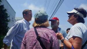 Congress Person Donald Norcross talks with 4 citizens in front of the Tesla dealership in Cherry Hill