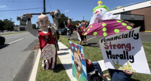 The CRI creative team protests at Whole Foods. Prominently displayed is a caricature of Jeff Bezos