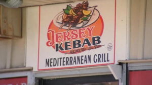 Shows the sign for the Jersey Kebab Mediterranean Grill