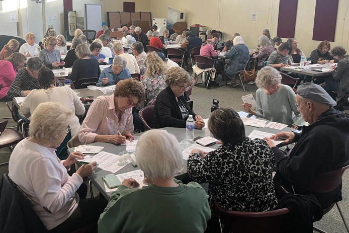 A room in the haddon township library. There are dozens of people filling out post cards as part of the "Missing Dems" Project