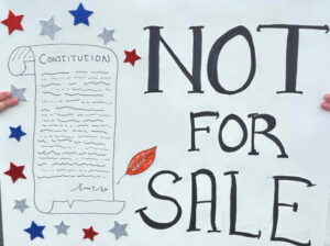 A sign from the protest. It says Not for Sale and it shows the US constitution