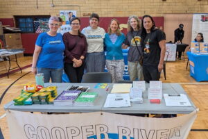 A small group from the Immigration Committee poses for a picture at a community event in Camden