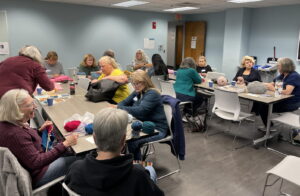 We are once again in the meeting room of the Voorhees Library and this time we have a group of people working on their projects that are part of the Stitches for Solidarity Group