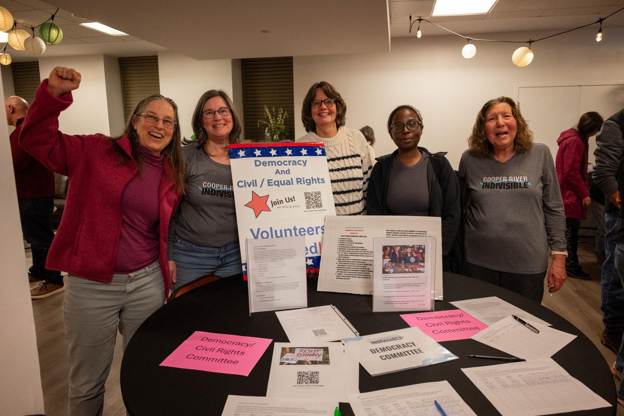 Members of the Democracy Committee stand behind their table at the February Meeting