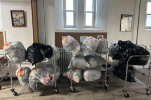 The basement of Sister's of Saint Marys. Bags of clothes hang out on rolling carts